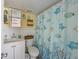 Well-lit bathroom with a vanity, patterned shower curtain, and coastal accents for a fresh feel at 2601 Gulf N Dr # 733, Bradenton Beach, FL 34217