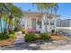 Charming coastal home featuring a coral door, lush landscaping, and a cozy, inviting entryway at 2601 Gulf N Dr # 733, Bradenton Beach, FL 34217