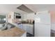 Efficient kitchen with white cabinetry and essential appliances, seamlessly blending with the living area at 2601 Gulf N Dr # 733, Bradenton Beach, FL 34217