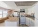Efficient kitchen with modern appliances, white cabinets, and a practical island countertop at 2601 Gulf N Dr # 733, Bradenton Beach, FL 34217