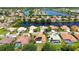Aerial view of a residential neighborhood surrounding interconnected ponds and well manicured lawns at 2729 Harvest Dr, Sarasota, FL 34240