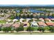 Stunning aerial view of homes with solar panels, a lake, and lush landscaping in a vibrant community at 2729 Harvest Dr, Sarasota, FL 34240