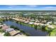 Wide aerial of homes lining a lake in an expansive residential neighborhood with manicured landscaping at 2729 Harvest Dr, Sarasota, FL 34240