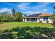Spacious backyard featuring a screen enclosed patio and solar panels on the terracotta tile roof at 2729 Harvest Dr, Sarasota, FL 34240