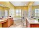 Bright bathroom featuring a large tub, glass-enclosed shower, and dual vanities at 2729 Harvest Dr, Sarasota, FL 34240