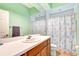 Cozy bathroom with a large mirror and fish-themed shower curtain at 2729 Harvest Dr, Sarasota, FL 34240