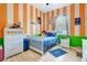 Charming bedroom features an orange/white striped wall, with hardwood floors and white trim at 2729 Harvest Dr, Sarasota, FL 34240