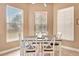 Sunny dining area featuring a stylish table, seating for six, and bright windows at 2729 Harvest Dr, Sarasota, FL 34240