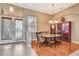 Dining room with hardwood flooring, a large window, and chandelier lighting at 2729 Harvest Dr, Sarasota, FL 34240