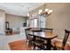 Open-concept dining room featuring hardwood flooring, a chandelier, and access to a bright living room at 2729 Harvest Dr, Sarasota, FL 34240