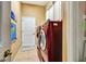 Practical laundry room with modern washer and dryer, tile floors and white door at 2729 Harvest Dr, Sarasota, FL 34240
