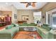 Spacious living room featuring hardwood floors, a large sectional sofa, and a ceiling fan at 2729 Harvest Dr, Sarasota, FL 34240
