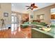 Open living space with hardwood floors, lots of seating, and easy access to kitchen and dining area at 2729 Harvest Dr, Sarasota, FL 34240