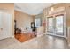 Comfortable living room featuring tiled entry, hardwood, and lots of natural light from front double doors at 2729 Harvest Dr, Sarasota, FL 34240