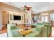 Open living space with hardwood floors, lots of seating, and a large built-in entertainment center at 2729 Harvest Dr, Sarasota, FL 34240