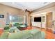 Bright and open living room with hardwood floors, ceiling fan, and natural light from large window at 2729 Harvest Dr, Sarasota, FL 34240