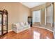 Spacious living room with hardwood flooring, a decorative curio cabinet, and ample natural light from large windows at 2729 Harvest Dr, Sarasota, FL 34240