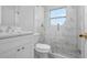 This bathroom features a modern design with elegant marble tiling, a glass-enclosed shower, and sleek fixtures at 2739 Palmadelia Ave, Sarasota, FL 34234