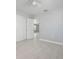 Well-lit bedroom with tiled floors, ceiling fan, closet and doorways to other rooms at 2739 Palmadelia Ave, Sarasota, FL 34234