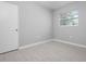 Cozy bedroom featuring tiled floors and a bright window, offering a comfortable and inviting atmosphere for relaxation at 2739 Palmadelia Ave, Sarasota, FL 34234