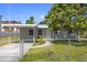 Charming single-story home featuring a covered parking area and fenced yard, offering both convenience and security at 2739 Palmadelia Ave, Sarasota, FL 34234