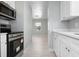 Modern kitchen showcases stainless steel appliances, white cabinetry, and sleek countertops, offering style and functionality at 2739 Palmadelia Ave, Sarasota, FL 34234