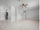 Spacious living room boasting neutral paint and tile floors throughout, complemented by a ceiling fan for added comfort at 2739 Palmadelia Ave, Sarasota, FL 34234