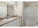 Cozy bathroom with vanity sink, mirror, and tub-shower combo with clear shower curtain at 27519 Pasto Dr, Punta Gorda, FL 33983