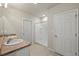 Bright bathroom featuring double sinks, neutral tile floors, and a glass-enclosed shower at 27519 Pasto Dr, Punta Gorda, FL 33983