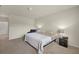 Large carpeted bedroom with reading chair, side tables, and neutral paint at 27519 Pasto Dr, Punta Gorda, FL 33983