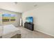 Bright bedroom features large window with blinds, neutral walls, and carpeted floors at 27519 Pasto Dr, Punta Gorda, FL 33983