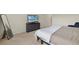 Bright bedroom features large window with blinds, neutral walls, and carpeted floors at 27519 Pasto Dr, Punta Gorda, FL 33983