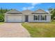 Charming single-story home with brick driveway, shutters, and attached two car garage at 27519 Pasto Dr, Punta Gorda, FL 33983