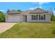 Charming single-story home with brick driveway, shutters, and attached two car garage at 27519 Pasto Dr, Punta Gorda, FL 33983