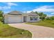 Charming single-story home with brick driveway, shutters, and attached two car garage at 27519 Pasto Dr, Punta Gorda, FL 33983