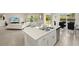 Bright open kitchen with large island and stainless dishwasher is open to living room and dining area at 27519 Pasto Dr, Punta Gorda, FL 33983