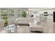 Bright living room with a white sectional, open to kitchen and dining areas at 27519 Pasto Dr, Punta Gorda, FL 33983