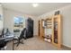 Bright office space featuring a glass desk, modern rolling chair, and built-in display shelves at 27519 Pasto Dr, Punta Gorda, FL 33983
