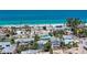 An aerial view of the community by the ocean and beautiful sandy beach at 301 Highland Ave # 3, Bradenton Beach, FL 34217