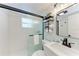 Modern bathroom with a sliding glass door, new fixtures and a shelf rack at 301 Highland Ave # 3, Bradenton Beach, FL 34217