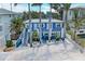 Bright blue two-story building with multiple parking spaces out front at 301 Highland Ave # 3, Bradenton Beach, FL 34217