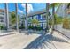 Bright blue two-story building with white trim and decorative palm trees around the property at 301 Highland Ave # 3, Bradenton Beach, FL 34217
