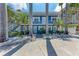 Charming blue two-story home with white trim, tropical landscaping, and reserved parking at 301 Highland Ave # 3, Bradenton Beach, FL 34217