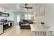 A well-lit living room features a sleek kitchen, comfortable seating, and a dining table at 301 Highland Ave # 3, Bradenton Beach, FL 34217