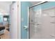 Bathroom with light blue walls and a shower featuring glass doors and a white shower surround at 307 White Oak Way, Sarasota, FL 34237