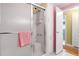Bathroom featuring a glass shower door, white tiled walls, and a built-in shower seat at 307 White Oak Way, Sarasota, FL 34237