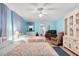 Bedroom featuring light blue walls, two beds with floral quilts, and mirrored closet doors at 307 White Oak Way, Sarasota, FL 34237