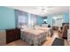Bedroom featuring light blue walls, two beds with floral quilts, and a ceiling fan at 307 White Oak Way, Sarasota, FL 34237