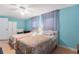 Cozy bedroom with two beds, floral bedding, and a calming blue color scheme at 307 White Oak Way, Sarasota, FL 34237