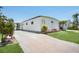 Well-maintained single-story home with manicured lawn and driveway, showcasing classic design at 307 White Oak Way, Sarasota, FL 34237